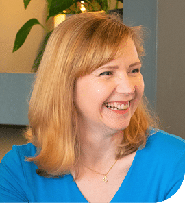 A headshot of Eleanor Deem, smiling and looking off camera