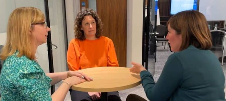 Picture of three women sitting round a table - attract HR consultancy clients