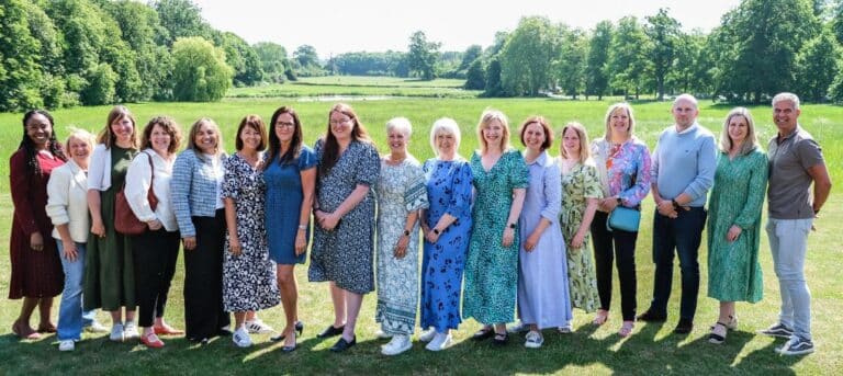Picture of a group of people standing together in a line - HR consultancy franchise