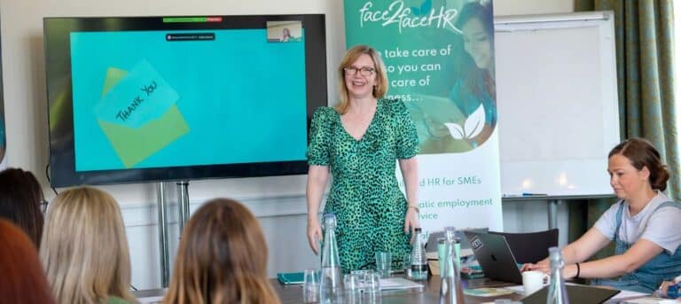 Image of a woman standing in front of a seminar - independent hr consultant