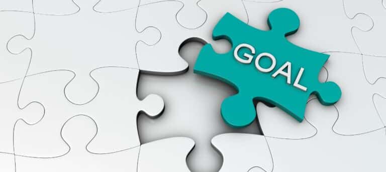 Image of jigsaw pieces with one piece set out and the word goal on it - HR consultancy business goals