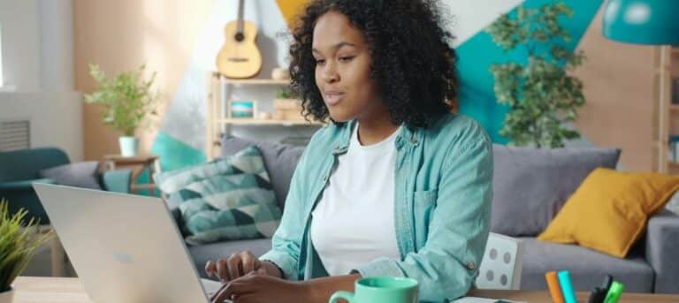 Image of a woman sitting at a laptop - first year HR consultant