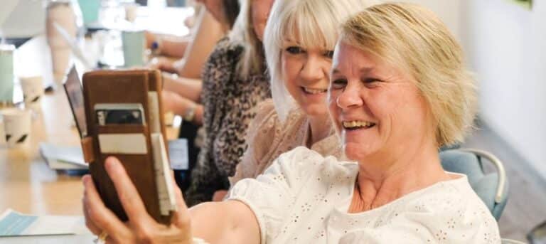 Image of two smiley women - mid-year HR business review
