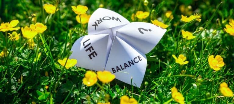 Photo of paper with worklife balance in a field of buttercups - sustainable HR consultancy career
